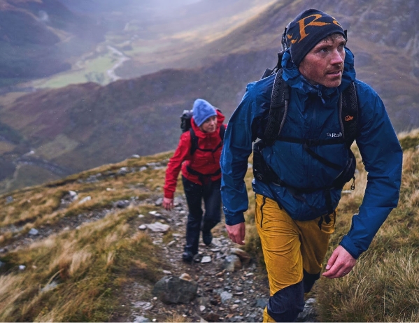 Two persons hiking up a mountain